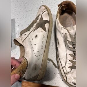 Very worn golden goose superstar sneakers